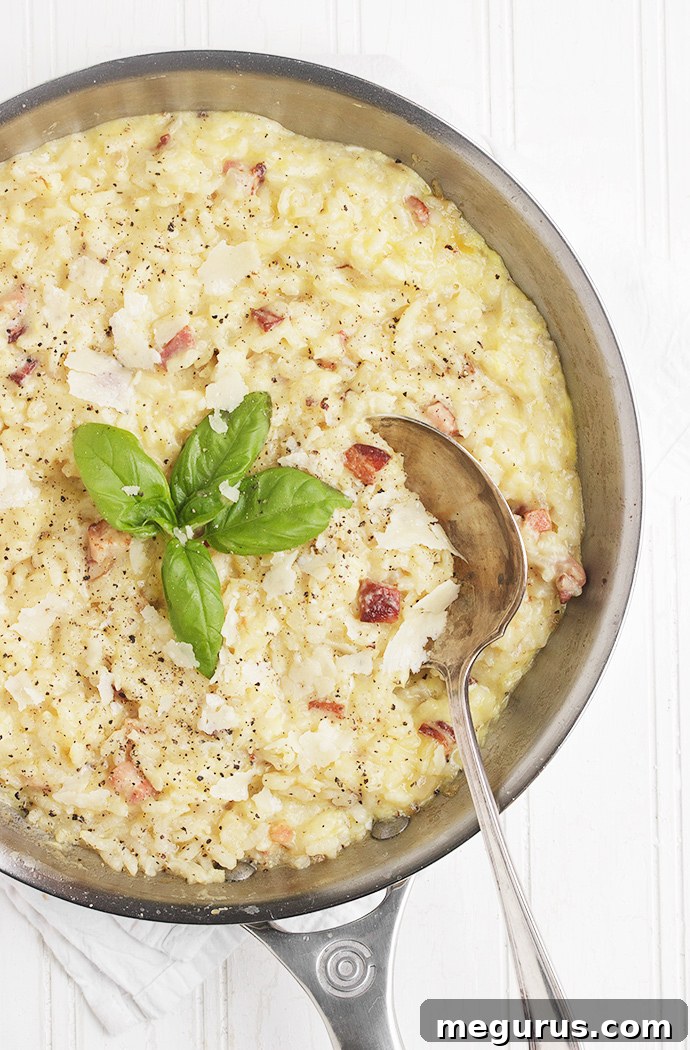 Close-up of creamy Baked Risotto Carbonara garnished with fresh parsley.