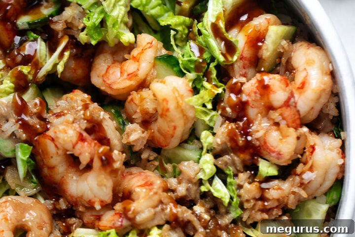Teriyaki shrimp with crispy rice in a serving bowl.