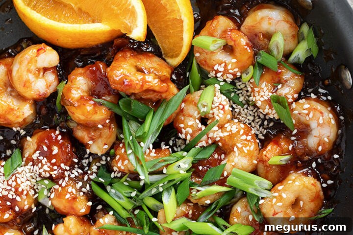 Spicy orange shrimp served in a skillet.