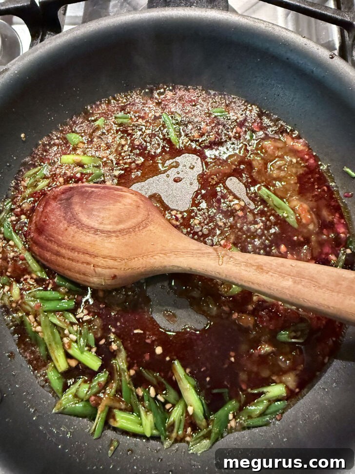 Cooking the spicy orange sauce down a bit.