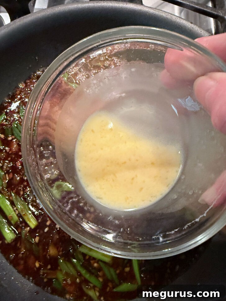 Adding thickener to the sauce.