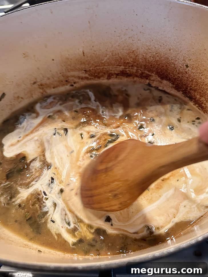 Adding heavy cream to the simmering pan drippings to create a rich gravy.