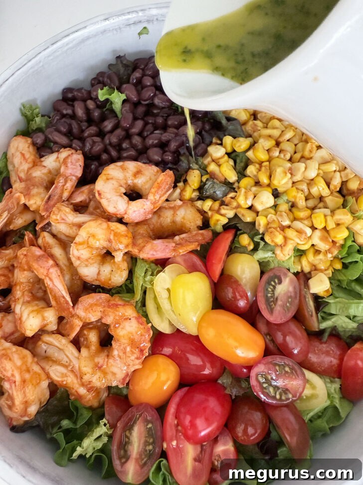 Drizzling the cilantro lime dressing over the salad.