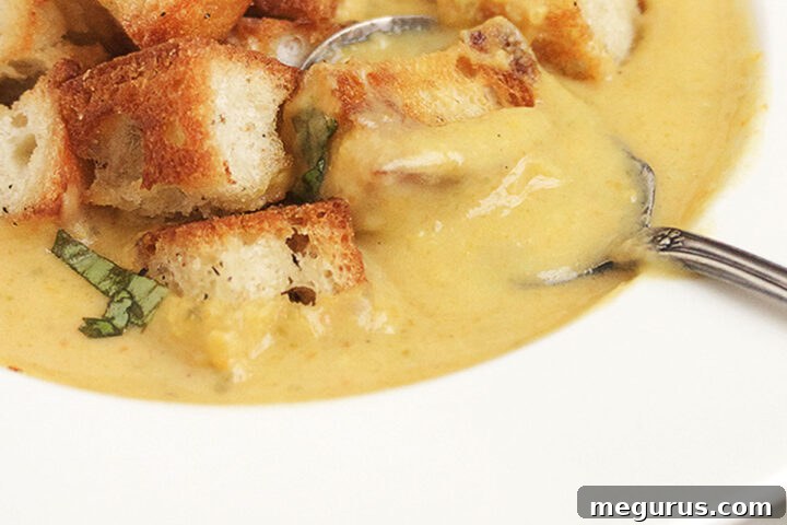 Creamy vegetable soup in a bowl with homemade croutons