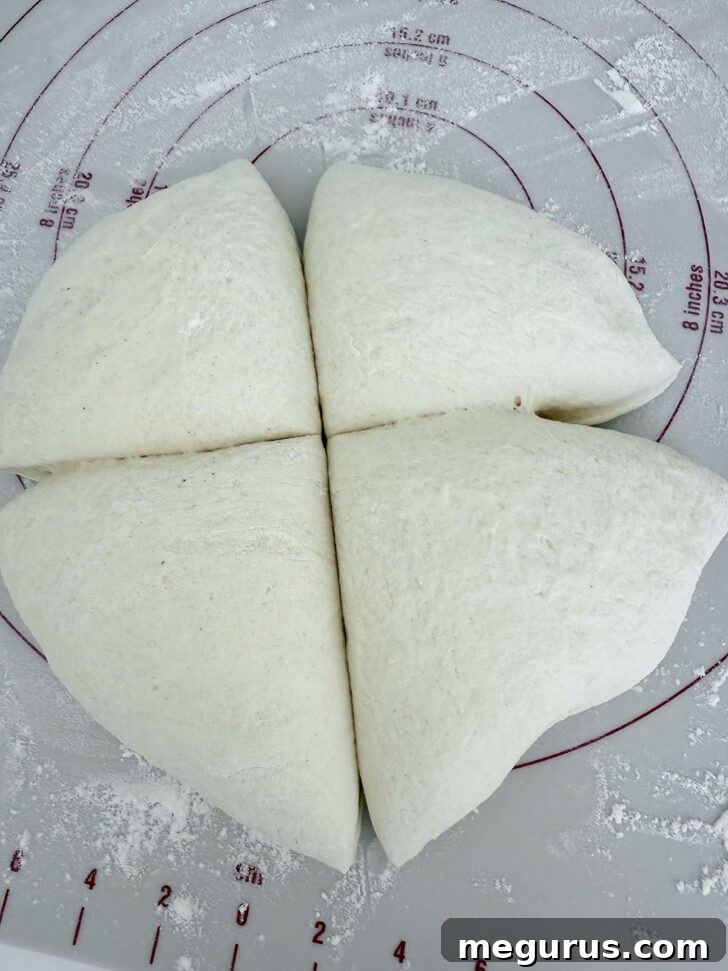 Pizza dough divided into 4 pieces.