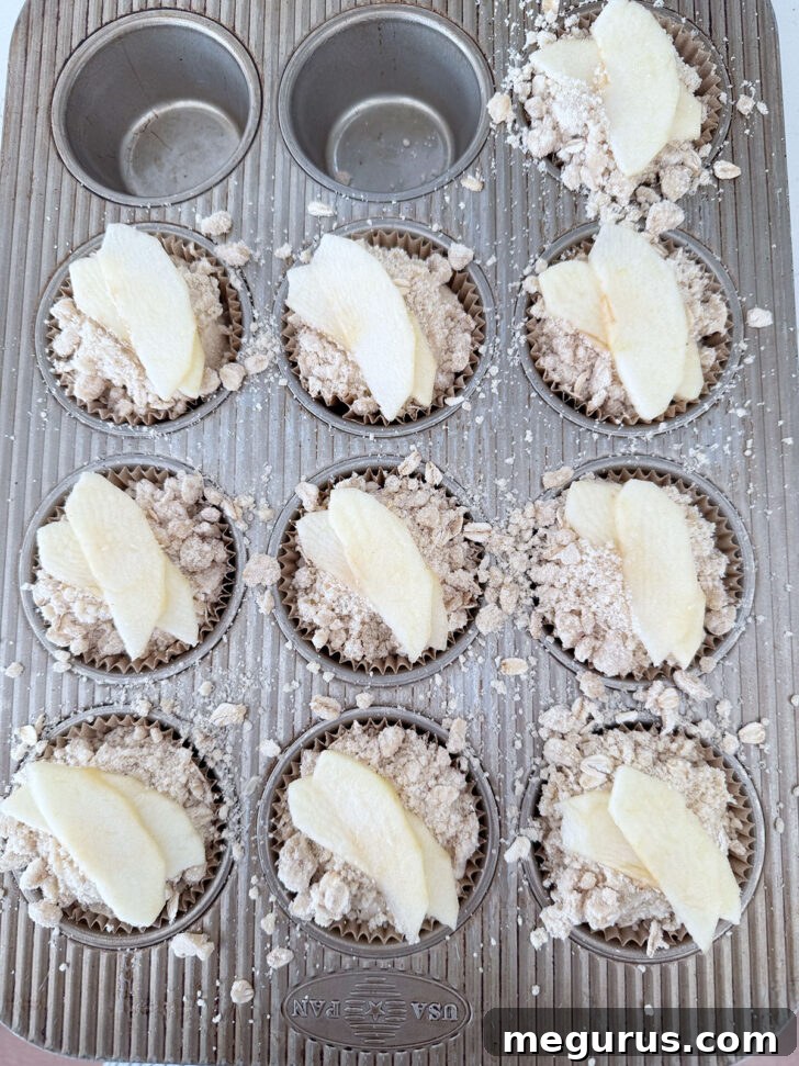 Apple slices placed on top of the muffins before baking.