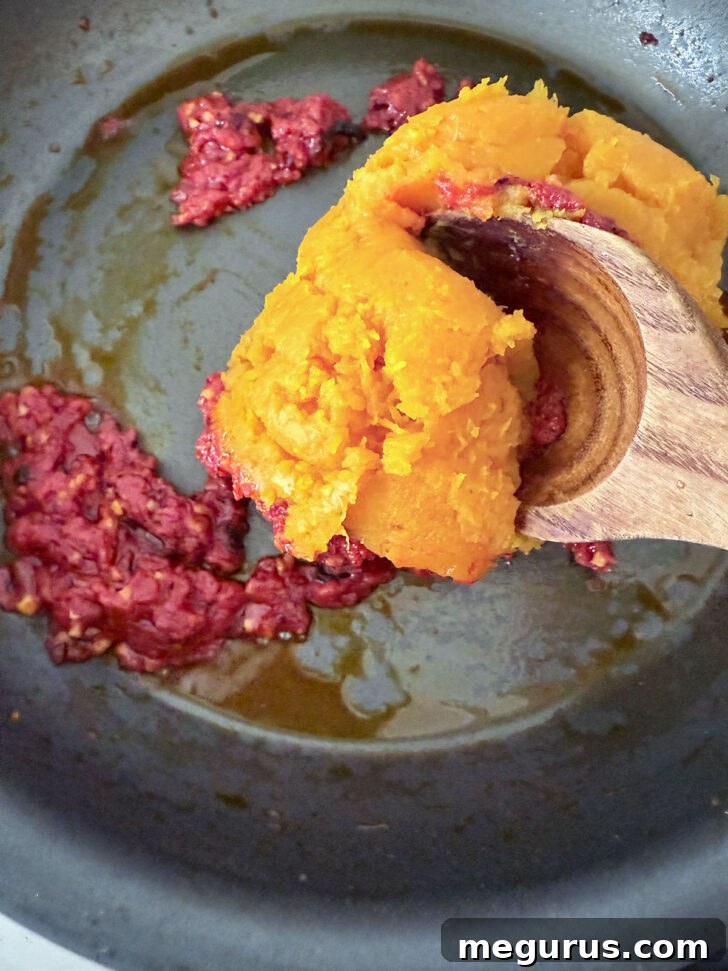 Adding the butternut squash to the skillet.