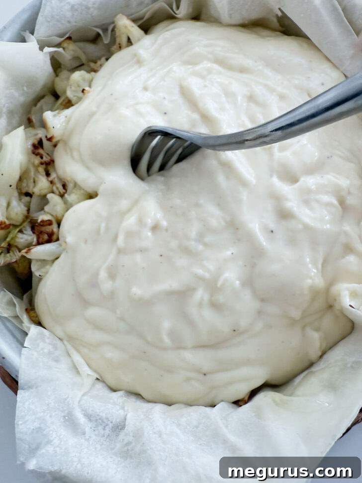 Creamy cheese sauce poured over the roasted cauliflower filling in the phyllo pie.