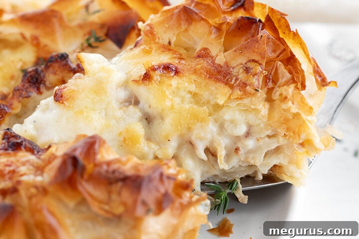 Cauliflower and Cheese Phyllo Pie, perfectly golden and sliced on a serving plate, ready to be enjoyed.