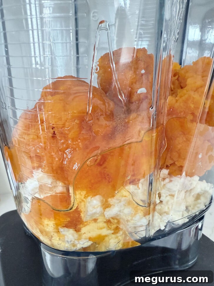 Butternut squash and feta being whipped in a food processor.