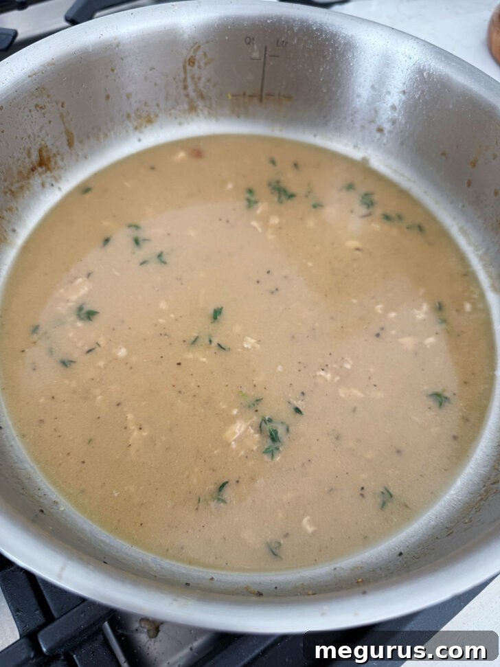 The rich and flavorful pan sauce simmering in the skillet, ready to serve.