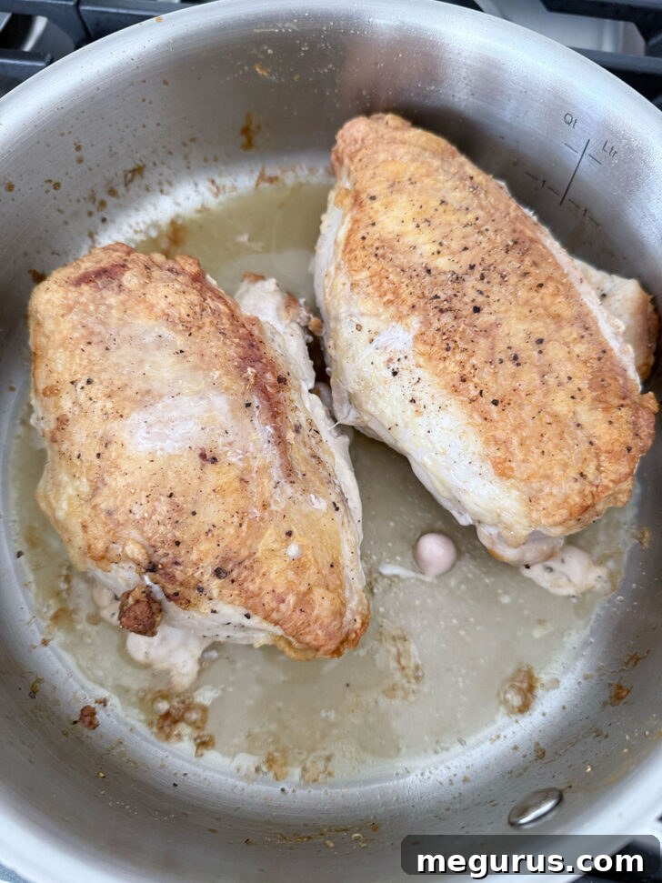 Cooked chicken breasts removed from the oven, with an internal temperature of 160F.