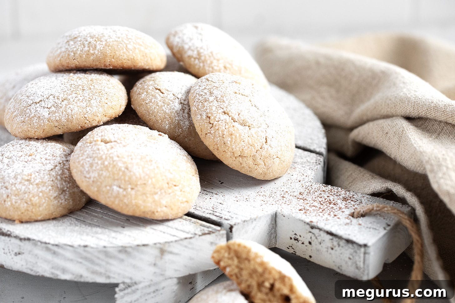 Golden brown butter cinnamon cookies arranged artfully on a rustic serving board, ready to be enjoyed with a hot beverage.