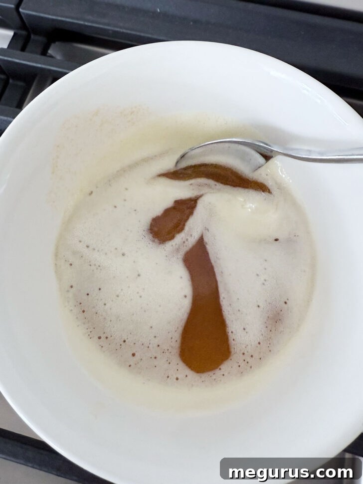 Richly browned butter, with golden-brown milk solids visible at the bottom, in a small bowl.