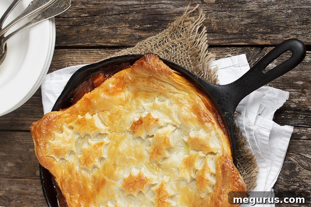 Hearty Skillet Beer-Braised Beef and Vegetable Pot Pie with a Golden Puff Pastry Topping
