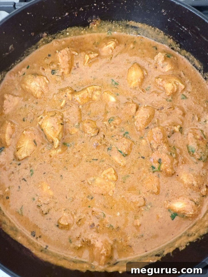 Finished butter chicken in a skillet.