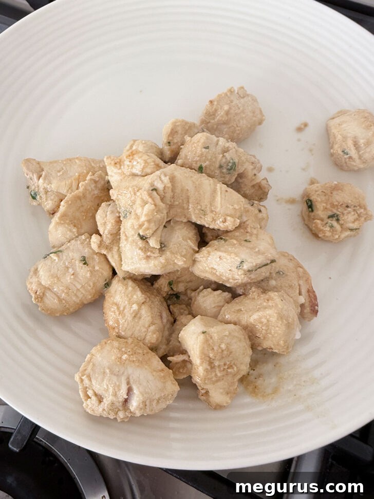 Cooked chicken removed to a plate.