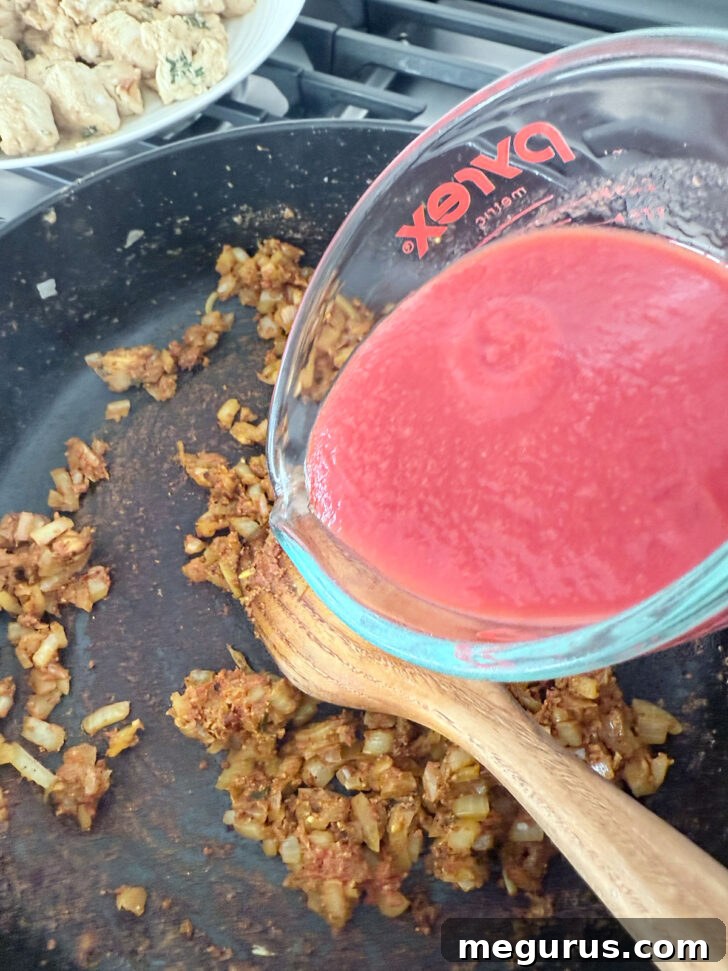 Adding the passata to the skillet.