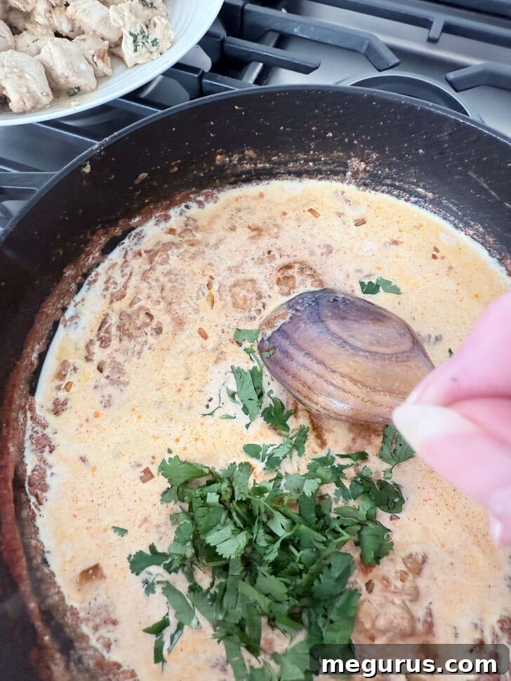 Adding the cilantro to the skillet.