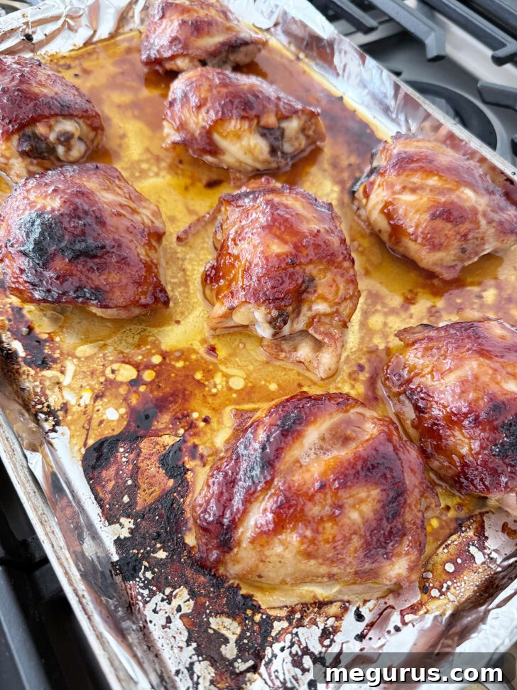 Finished honey soy chicken thighs on the baking sheet.