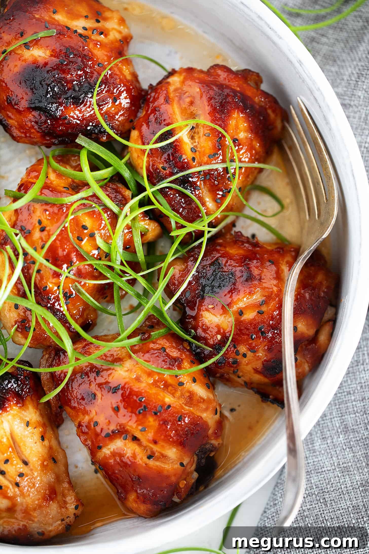 Honey soy chicken in a serving dish with a fork.