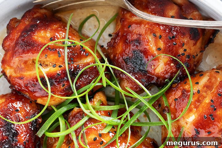 Honey soy chicken in a serving dish with a fork.