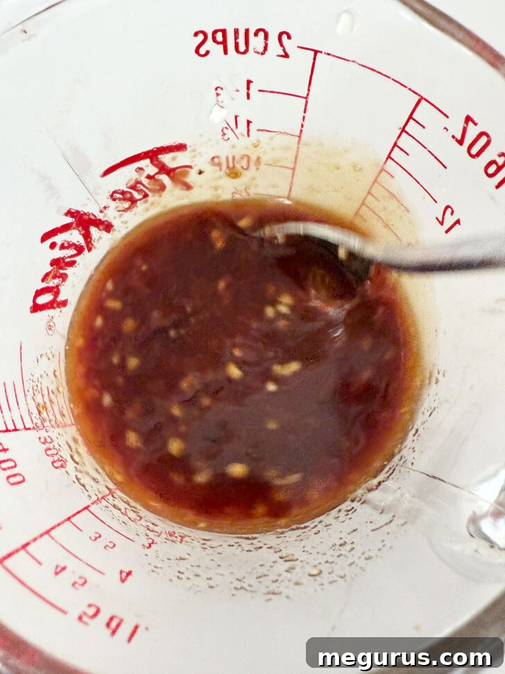 Mixing the marinade ingredients in a measuring cup.