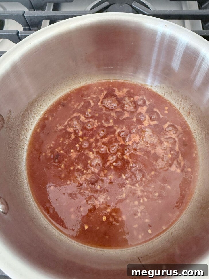 Boiling the remaining marinade in a saucepan.