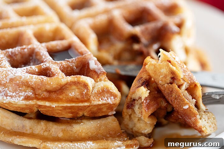 Beautifully plated Apple Fritter Waffles, glazed and ready to eat, with a hint of maple syrup.