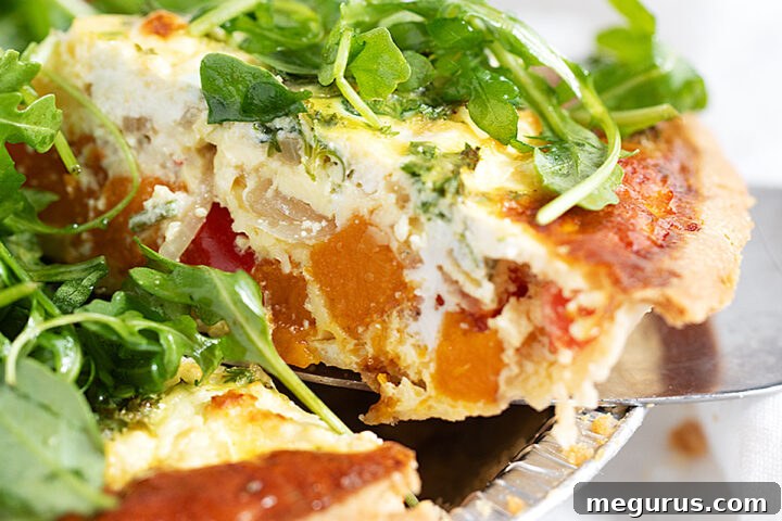 Butternut squash quiche sliced, showing the rich filling.