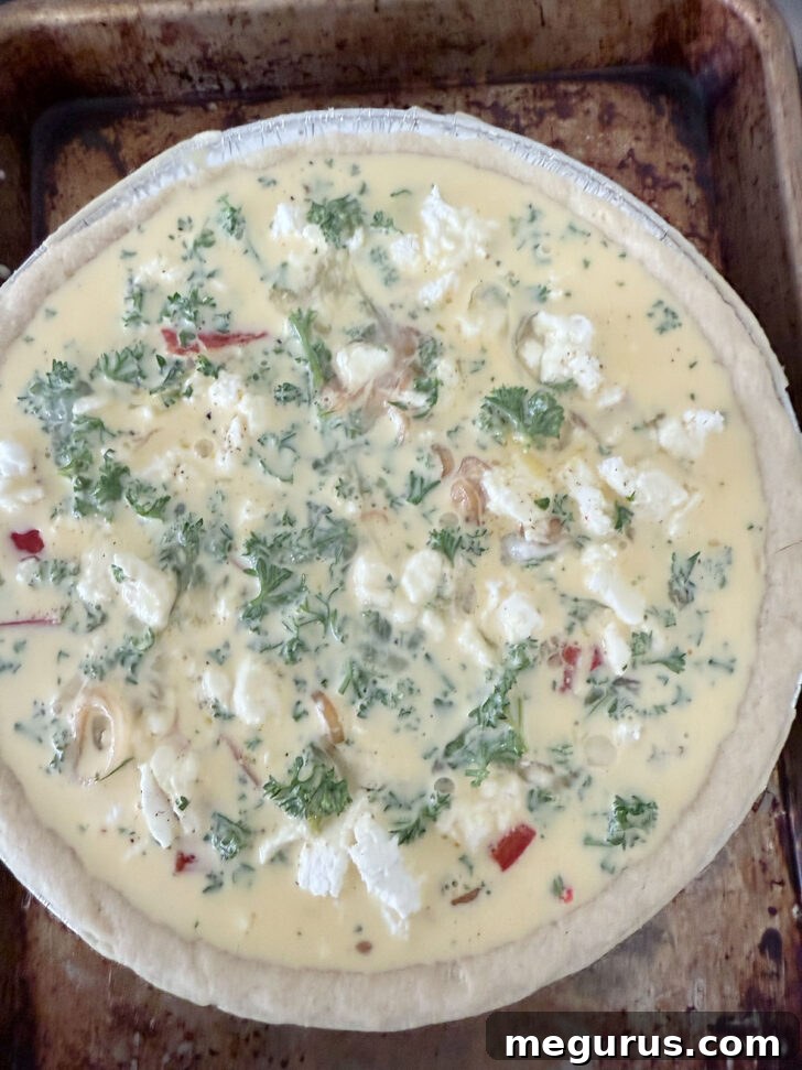 Butternut squash quiche ready for the oven, filled and smooth.