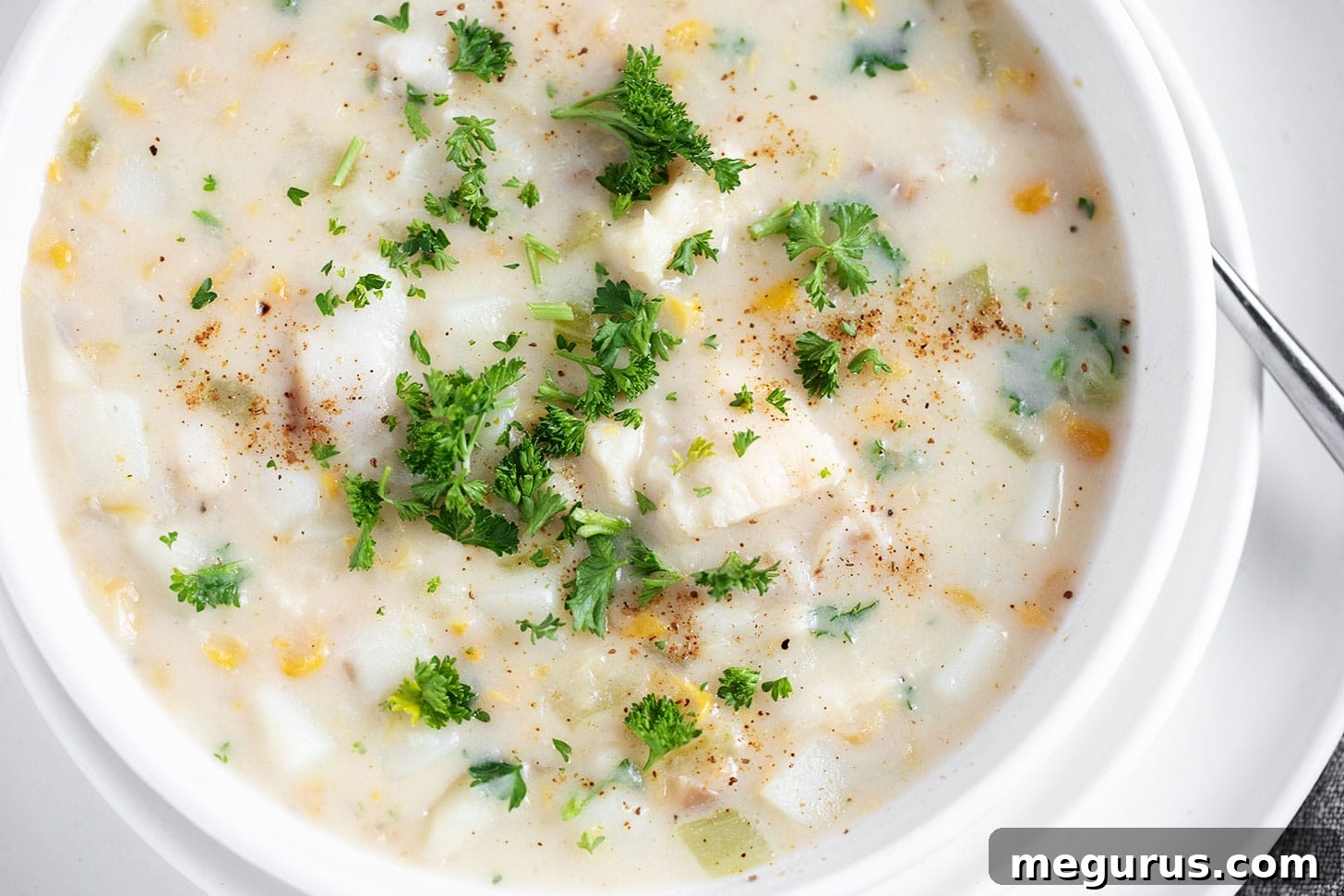 A steaming bowl of Easy Cod Chowder, garnished with fresh parsley.