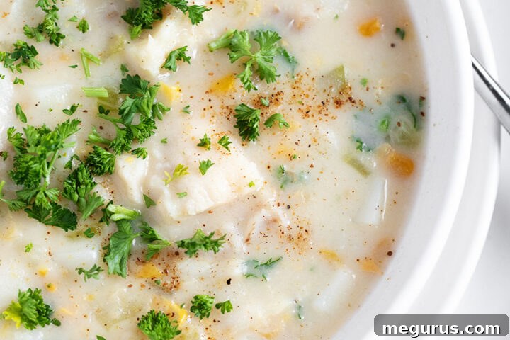 Cod chowder in a white bowl.