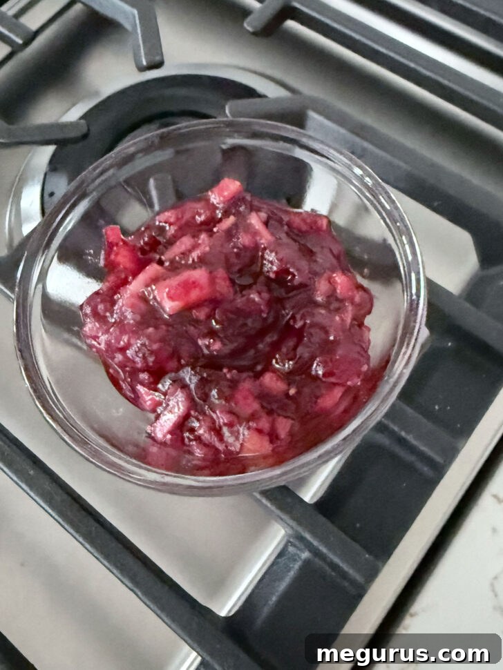 Setting aside some of the cranberry apple mixture for serving as a condiment.