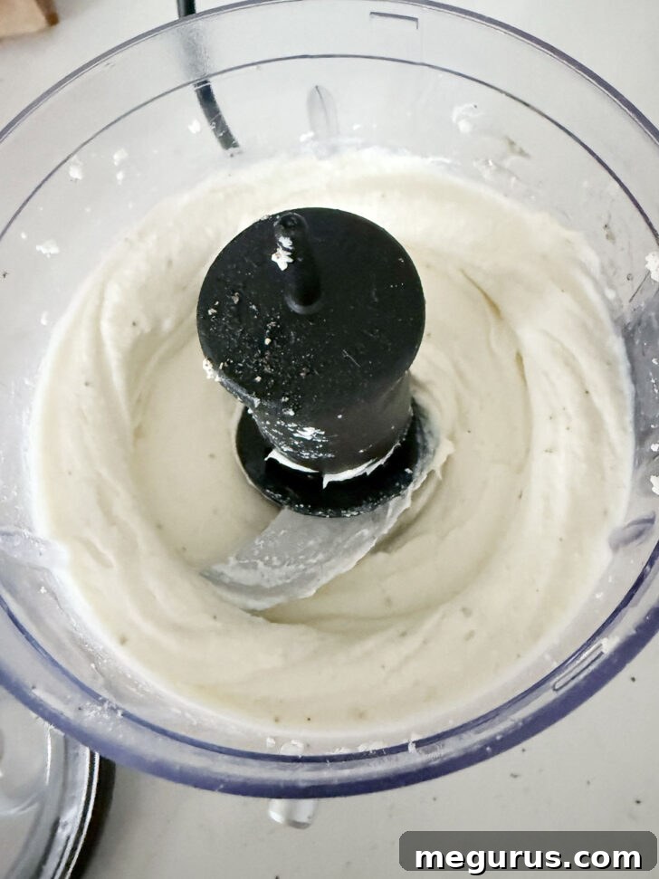 Smooth, creamy whipped ricotta after processing, ready to be spread.