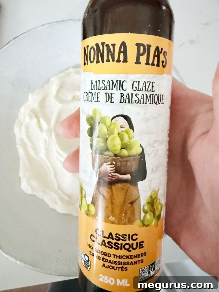 A bottle of balsamic glaze, showing the consistency before drizzling over the whipped ricotta.