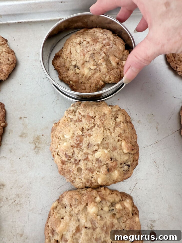 A metal ring used to gently shape a warm cookie into a perfect round immediately after baking.