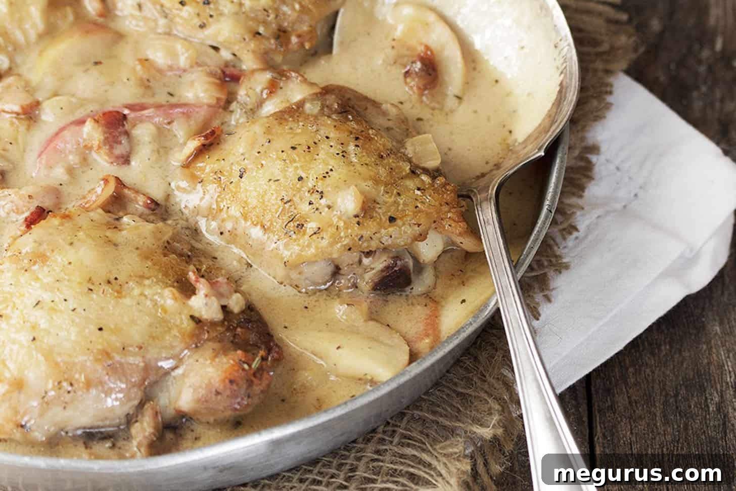chicken thighs with apples and bacon in skillet