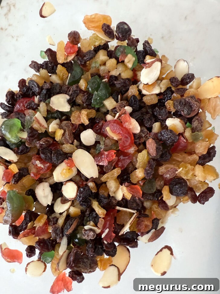Dried fruit for Christmas pudding in a bowl, including raisins, currants, and mixed peel.