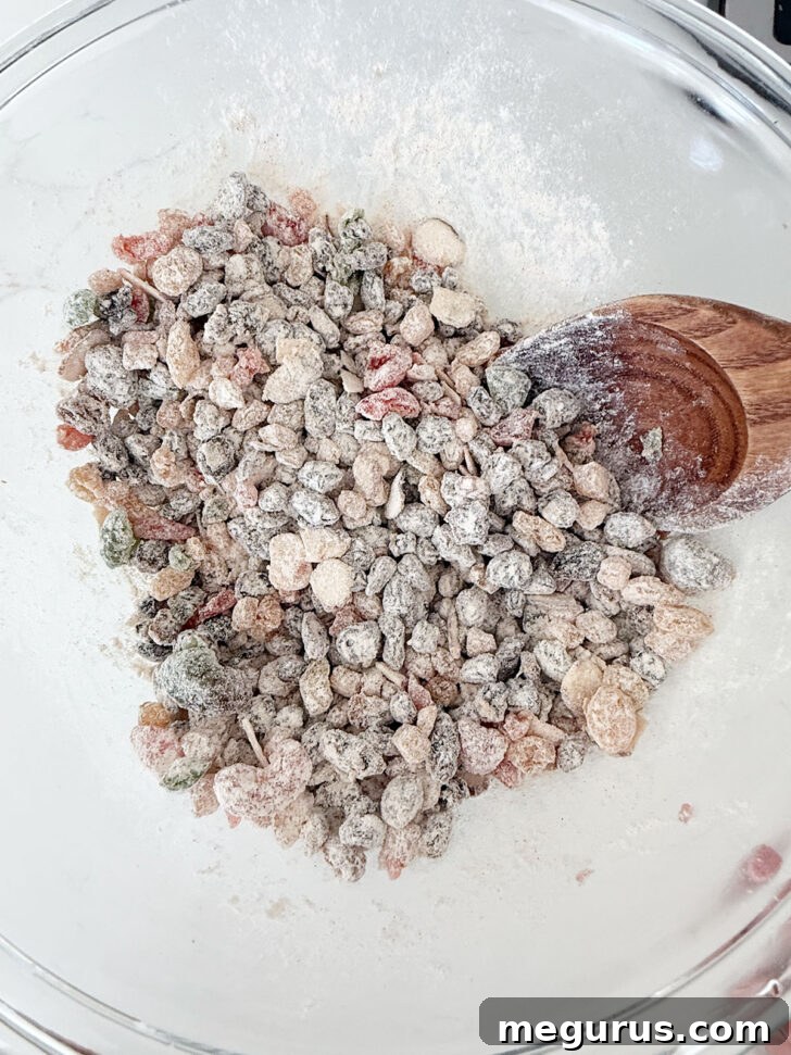 Dried fruit combined with the dry ingredients in a bowl, ready for mixing.