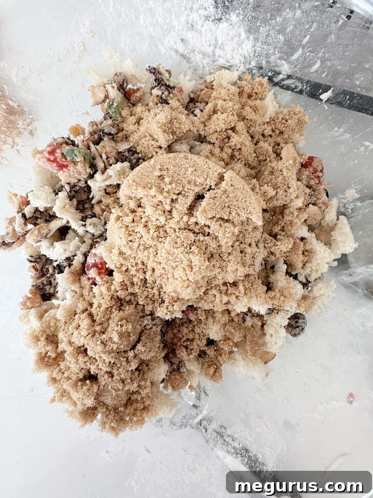 Brown sugar and fresh bread crumbs added to the mixture in the bowl.