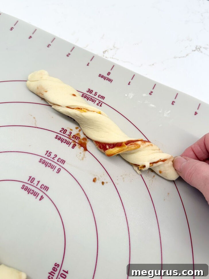 A single strip of dough being twisted by hand.