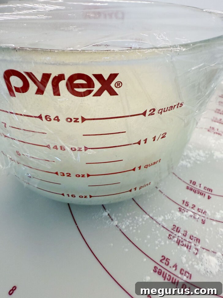 Dough beautifully risen and doubled in size within the measuring cup.