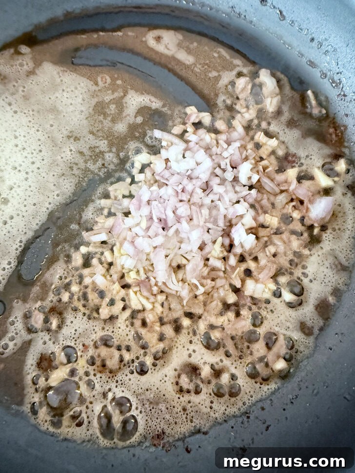 Shallots and garlic cooking in butter in the skillet.