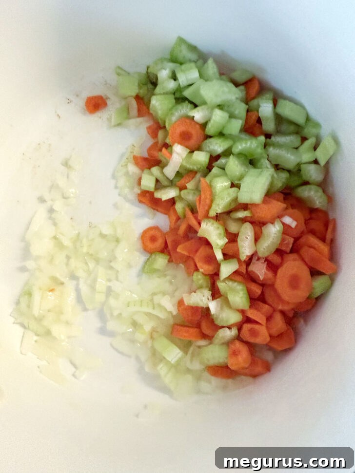 Onion, carrot and celery added to the soup pot.