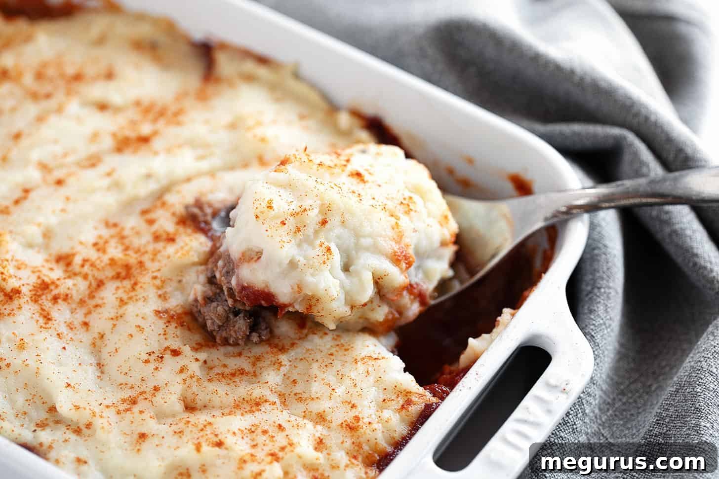 Meatloaf casserole in a baking dish, showcasing its mashed potato topping and rich meat layer.