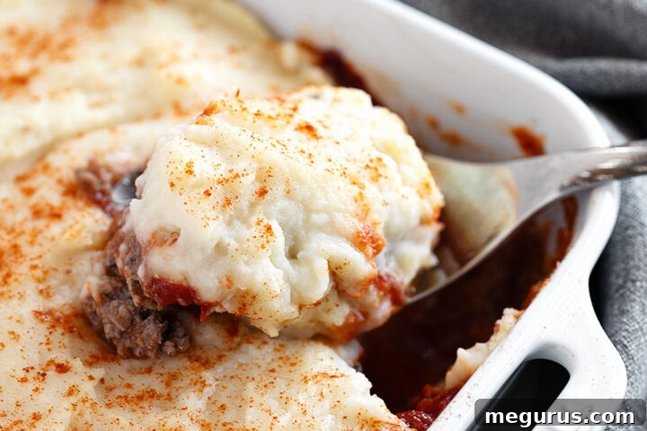Meatloaf casserole in a baking dish, perfectly cooked with a golden mashed potato topping.