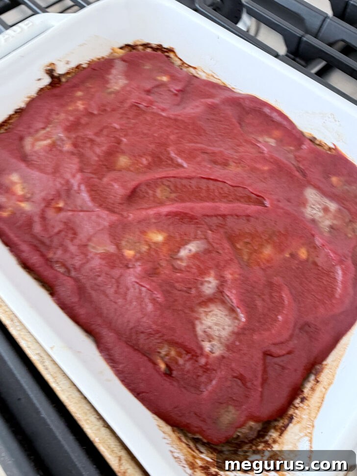 Casserole after baking with the tomato layer, ready for mashed potatoes.