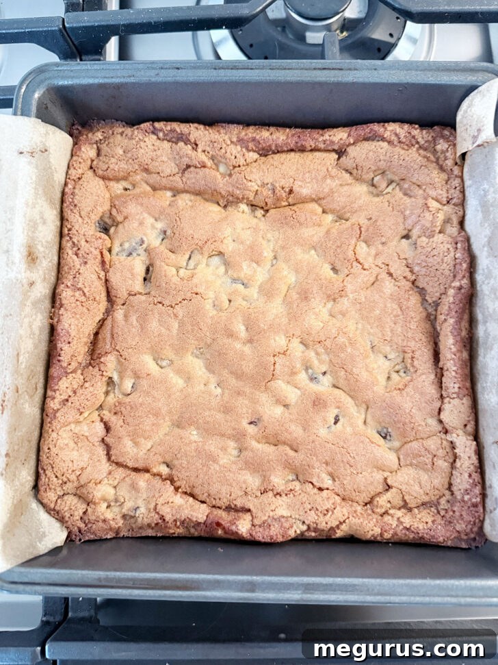 Golden brown, perfectly baked date and nut chews in the baking pan.