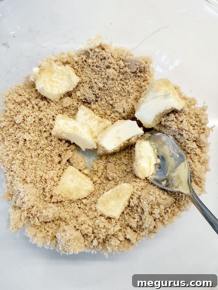 Softened butter and brown sugar are combined in a mixing bowl.